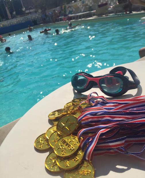 Summer pool, gold medals, goggles: joy and competition.